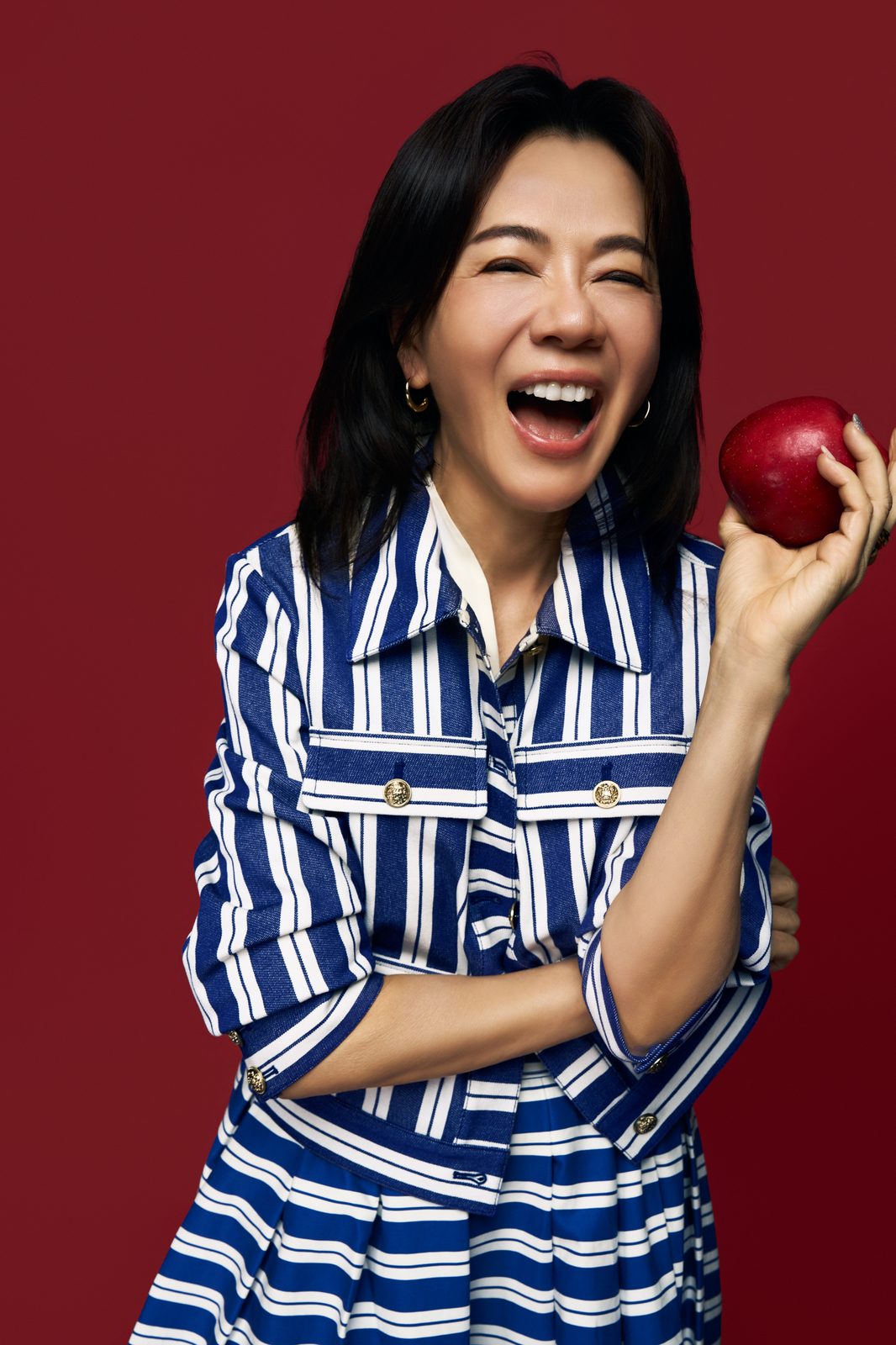 Rose Tsou laughing, holding a red apple